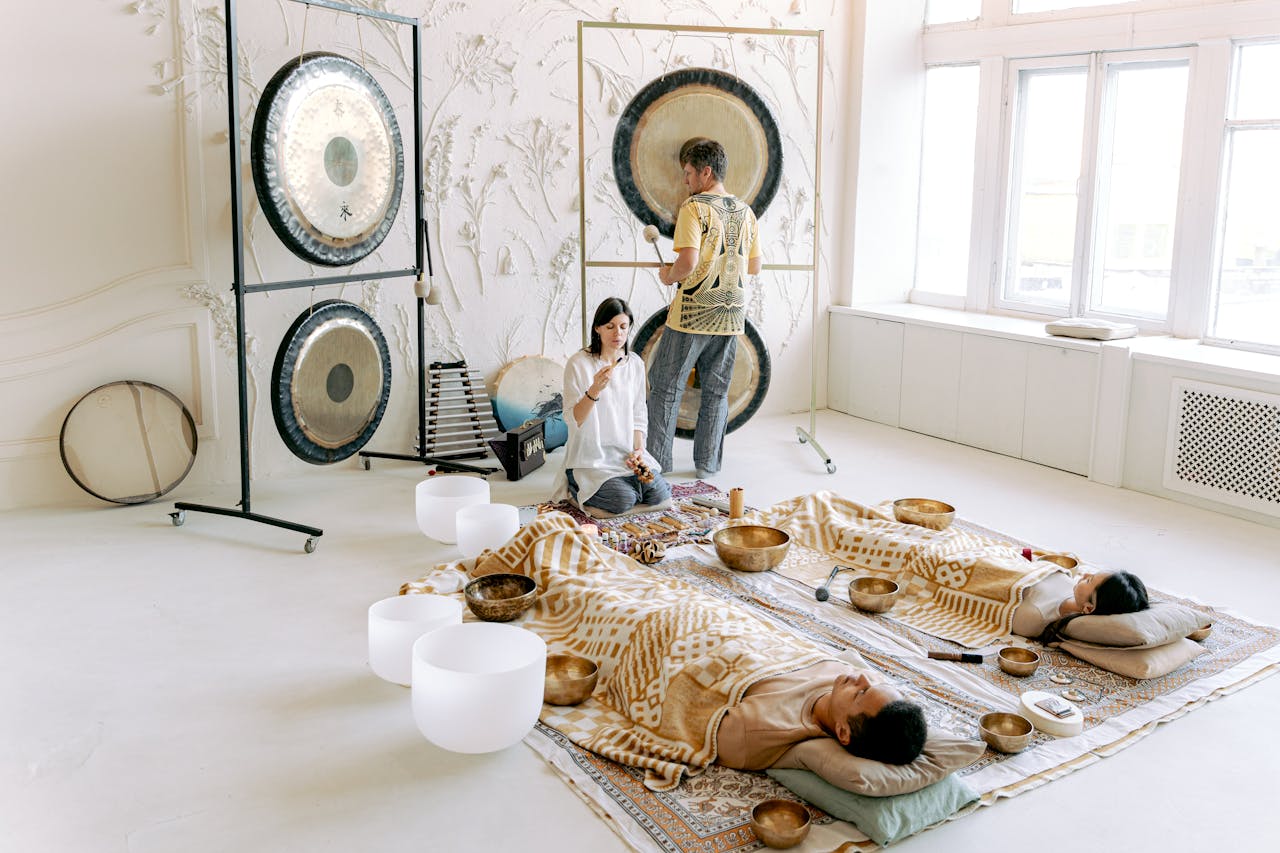 A serene indoor sound bath session with gongs and singing bowls promoting relaxation and wellness.